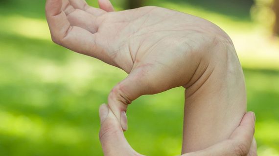 A child stretching their hand. 